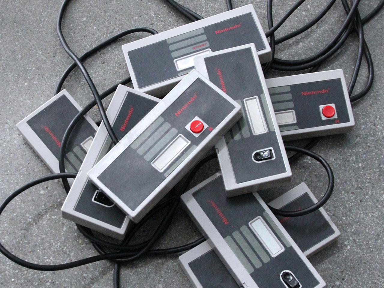 A close-up photograph of the Octopad's eight one-switch controllers in a pile on the ground.