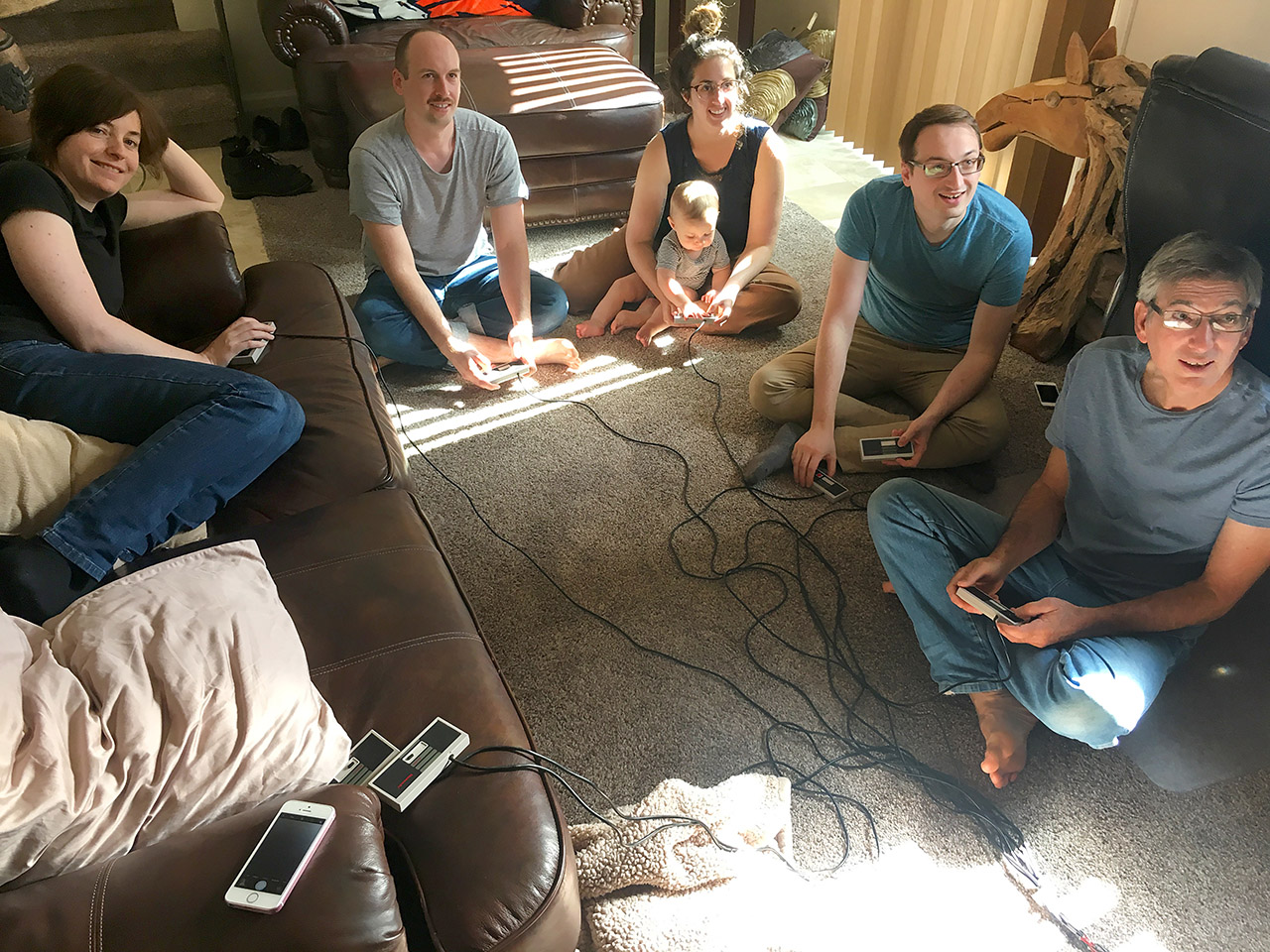A family casually playing together in a livingroom in Denver.