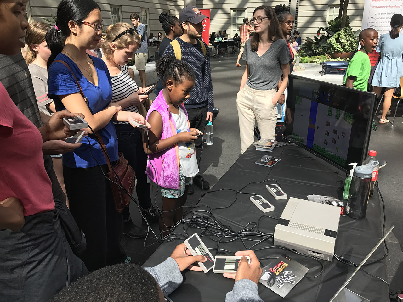 A group of people playing together at the Smithsonian Museum of American Art's annual arcade in DC.